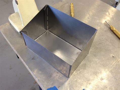 a metal worker is making a box|how to cut sheet metal box.